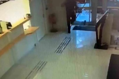 Kaldırım taşıyla bankanın camını kırdıktan sonra aramadık yer bırakmayan hırsızın eli boş döndüğü anlar kameraya yansıdı
